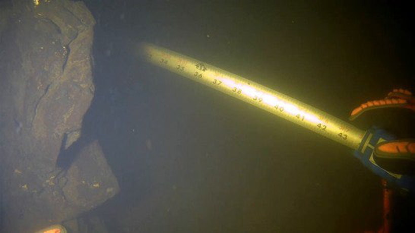 Reach DDCS frame of a folding ruler held against a submerged member, graduations legible